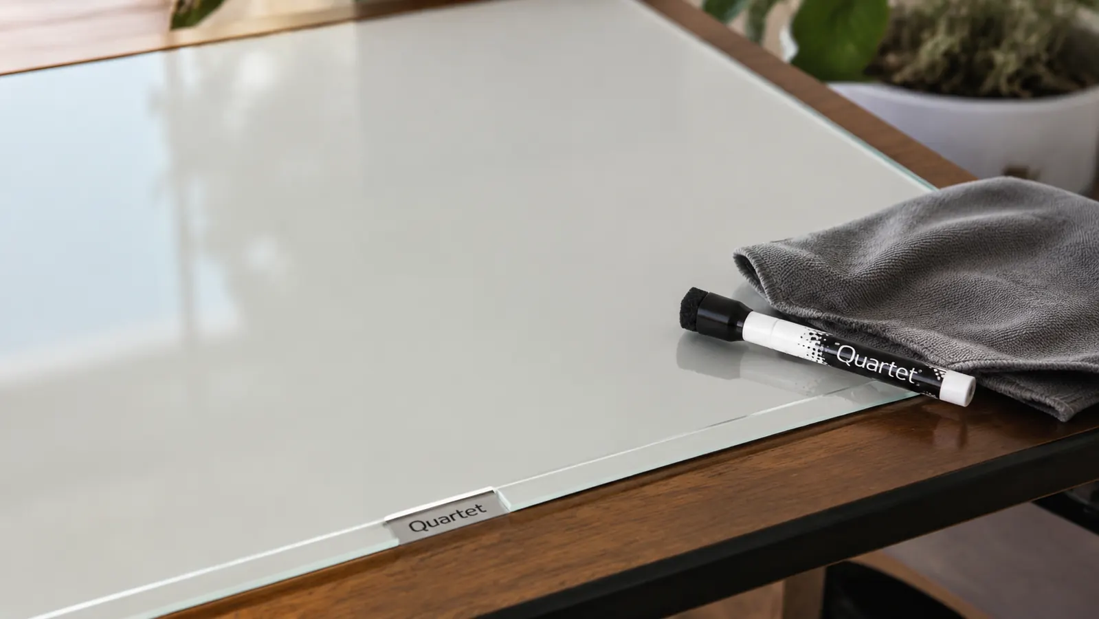 Close-up of the glass whiteboard surface after being wiped clean, showing no ghosting or staining