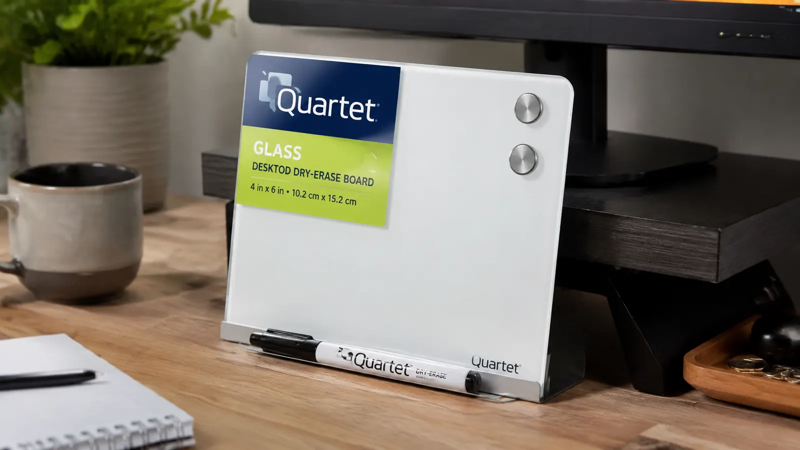 Small glass dry erase whiteboard propped up on a desk next to a keyboard